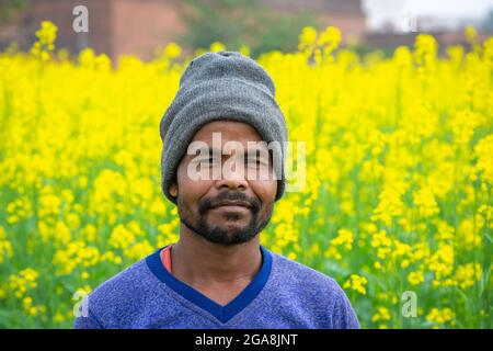 TIKAMGARH, MADHYA PRADESH, INDIA - JULY 23, 2021: Indian farmer standing in agricultural field. Stock Photo