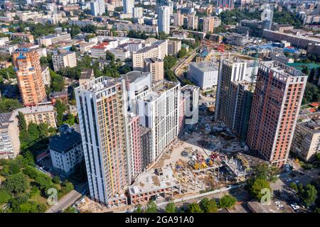Aerial photography of residential areas of the city with a view of new skyscrapers under construction, aerial view, city photography. Copy space. Stock Photo