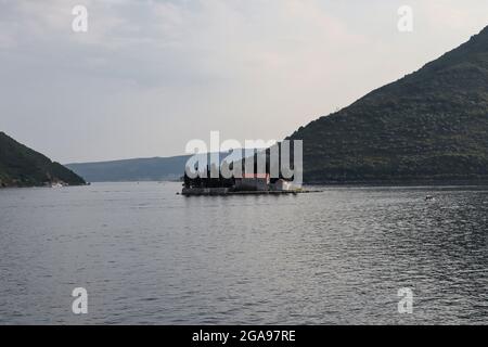 Perast, Montenegro - July 20, 2021 Islands Saint George with the Catholic monastery in Bay of Kotor Stock Photo