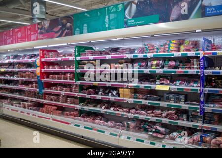 Taplow, Buckinghamshire, UK. 22 July, 2021. Meat supplies. Shelves in Sainsbury's Supermarket were generally very well stocked this morning. The main exception was for mineral water as people have been buying more than normal due to the heatwave. Following the Covid-19 lockdown lifting on Monday, Sainsbury's have new signs outside their store asking customers to wear masks if they can. Credit: Maureen McLean/Alamy Stock Photo