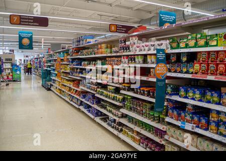 Taplow, Buckinghamshire, UK. 22 July, 2021. Shelves in Sainsbury's Supermarket were generally very well stocked this morning. The main exception was for mineral water as people have been buying more than normal due to the heatwave. Following the Covid-19 lockdown lifting on Monday, Sainsbury's have new signs outside their store asking customers to wear masks if they can. Credit: Maureen McLean/Alamy Stock Photo