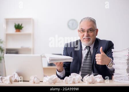 Old businessman employee in brainstorming concept Stock Photo