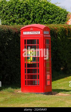 A K6 red phone box converted to a medical defibrillator in Sand le Mere in East Yorkshire,UK Stock Photo