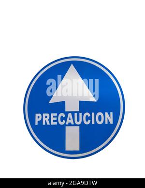 round blue sign with an arrow indicating caution in Spanish letters on white background with copy space Stock Photo