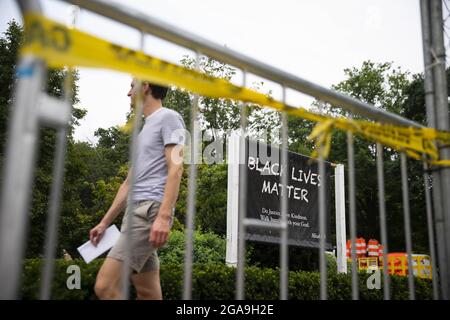 Washington, United States. 29th July, 2021. A man walks by a sign in Black Lives Matter Plaza near the White House in Washington, DC, on Thursday, July 29, 2021. Photo by Sarah Silbiger/UPI Credit: UPI/Alamy Live News Stock Photo