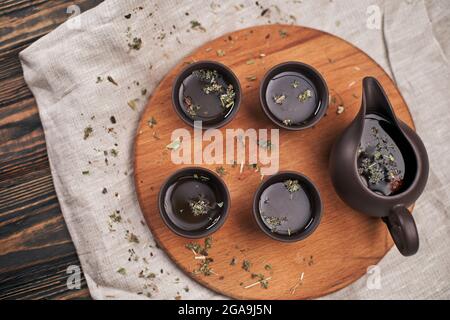 tea set and green tea leaves on a wooden board Stock Photo