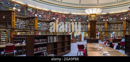 LIVERPOOL, UK - JULY 14 : Traditional wood paneled library in Liverpool, England UK on July 14, 2021. Three unidentified people Stock Photo