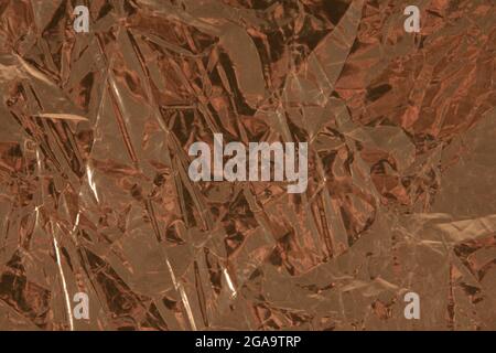 Background with golden crumpled sheet of paper with vignetting Stock Photo