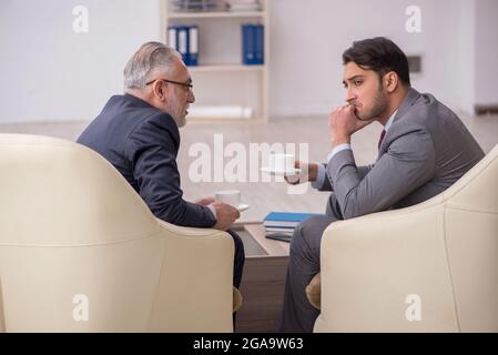 Two businessmen discussing project in the office Stock Photo