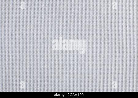 White fabric close up. Weaving of individual threads. Knitted polyester. Low pile synthetic fiber Stock Photo
