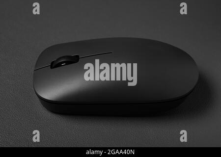 side view black wireless mouse on a dark background Stock Photo
