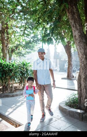 father walk her child to school in the morning Stock Photo