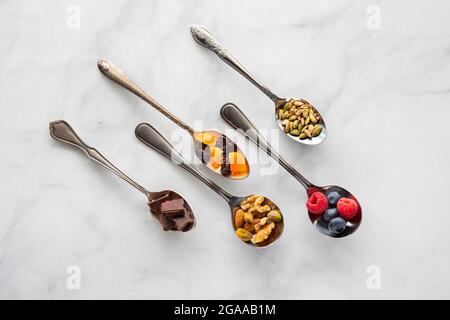 Top down view of fresh healthy ingredients in various vintage spoons. Stock Photo