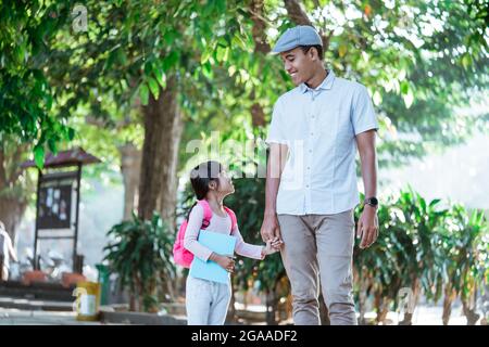 father walk her child to school in the morning Stock Photo