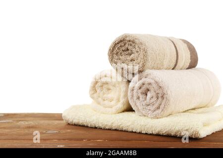 https://l450v.alamy.com/450v/2gaam8b/rolled-bath-towels-on-wooden-table-closeup-2gaam8b.jpg