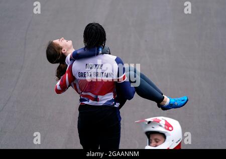 Great Britain's Silver medalist Kye Whyte helps carry Bethany Shriever after she wins Gold in the Cycling BMX Racing at the Ariake Urban Sports Park on the seventh day of the Tokyo 2020 Olympic Games in Japan. Picture date: Friday July 30, 2021. Stock Photo