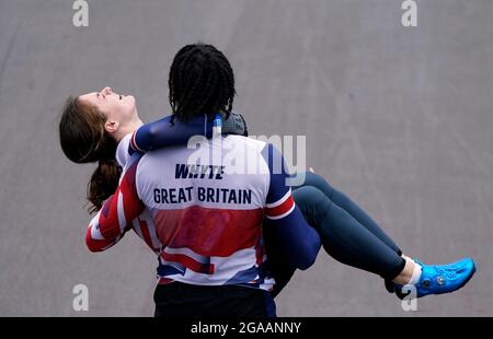 Great Britain's Silver medalist Kye Whyte helps carry Bethany Shriever after she wins Gold in the Cycling BMX Racing at the Ariake Urban Sports Park on the seventh day of the Tokyo 2020 Olympic Games in Japan. Picture date: Friday July 30, 2021. Stock Photo