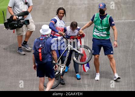 Great Britain's Silver medalist Kye Whyte helps Bethany Shriever after she wins Gold in the Cycling BMX Racing at the Ariake Urban Sports Park on the seventh day of the Tokyo 2020 Olympic Games in Japan. Picture date: Friday July 30, 2021. Stock Photo