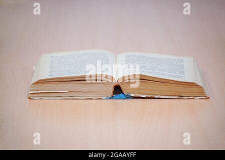 An open book on a wooden table. Selective focus Stock Photo