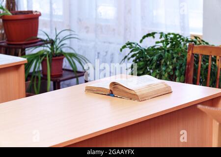 An open book on a wooden table. Selective focus Stock Photo