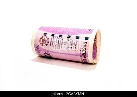 Indian two thousand rupees rolled up banknote isolated on white background. Stock Photo