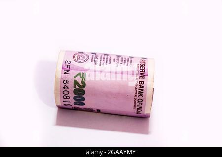 Indian two thousand rupees rolled up banknote isolated on white background. Stock Photo