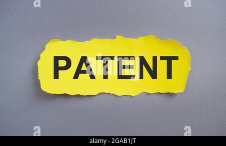 Patent word written on yellow torn paper, Business concept. Stock Photo