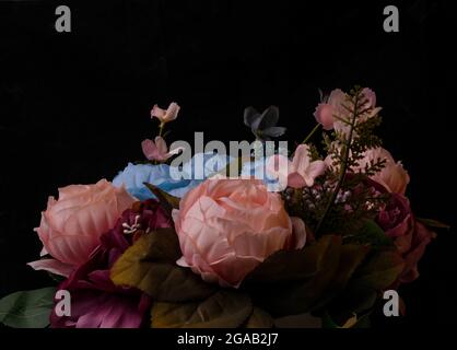Vibrant Still Life of Artificial Flowers in a Vase. Stock Photo