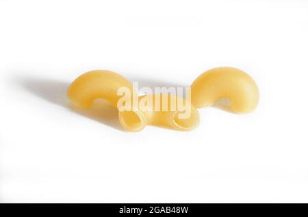 Three macaroni horns isolated on a white background with a shadow.  Stock Photo