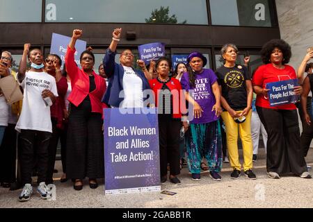 Washington, DC, USA. 29th July, 2021. Pictured: Voting rights activists block the entrance to the Hart Senate Building in a civil disobedience action at a speak-out event hosted by the National Coalition on Black Civic Participation. Left to right: Dr. Johnnetta Cole, Rev. Jared Sawyer Jr, Cora Masters Barry, Rev. Dr. Barbara Williams-Skinner, Melanie Campbell, Congresswoman Sheila Jackson Lee (D-TX), Faya Toure, Arlene Holt-Baker, and Sheila Tyson. Credit: Allison Bailey/Alamy Live News Stock Photo