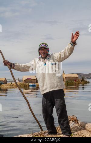 TITICACA, PERU - MAY 15, 2015: Boatman, inhabitant of Uros floating islands, Titicaca lake, Peru Stock Photo
