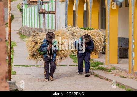 AMANTANI, PERU - MAY 15, 2015: Native peasants with their srop in a village on Amantani island in Titicaca lake, Peru Stock Photo