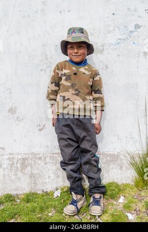 AMANTANI, PERU - MAY 15, 2015: Native boy in a village on Amantani island in Titicaca lake, Peru Stock Photo