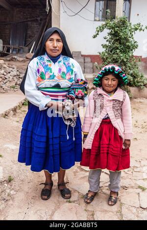 AMANTANI, PERU - MAY 15, 2015: Members of a native family living on Amantani island in Titicaca lake, Peru Stock Photo