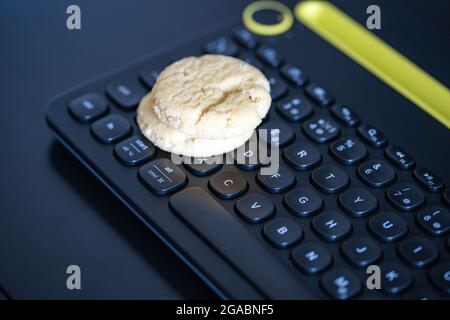 Cookies on a keyboard symbolizing browser cookies on internet. Stock Photo