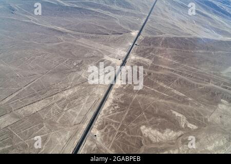 Aerial view Panamericana highway crossing the geoglyphs near Nazca - famous Nazca Lines, Peru. On the right side, observation tower is present. Stock Photo