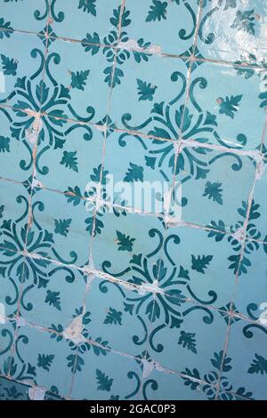 Traditional glazed blue and turquoise green or teal ceramic tiles or azulejos which cover many buildings in Lisbon, Portugal. Stock Photo
