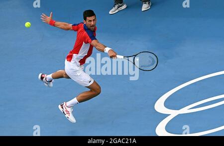 Tokio, Japan. 30th July, 2021. Tennis: Olympics, Preliminary, Singles, Men, Semifinals Djokovic (Serbia) - Zverev (Germany) at Ariake Tennis Centre. Novak Djokovic plays a backhand. Credit: Marijan Murat/dpa/Alamy Live News Stock Photo