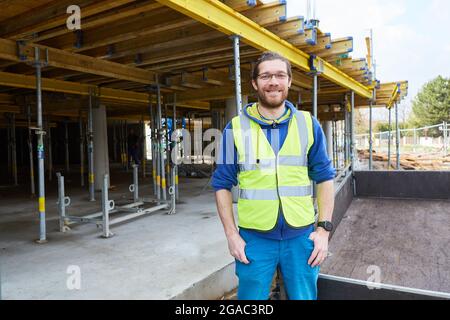 Young man as a craftsman apprentice on a shell construction site for a house as a new building Stock Photo