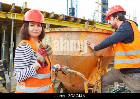 Construction workers team works on cement mixer on the new building construction site for house building Stock Photo