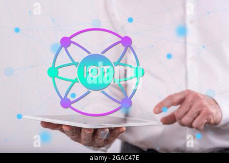 Iot concept above a tablet held by a man in background Stock Photo