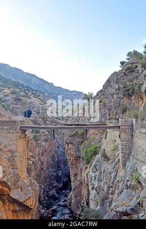 Very narrow bridge between two mountains of the Caminito del Rey in Desfiladero de los Gaitanes de Sierra de Ardales, Malaga, Andalusia, Spain Stock Photo