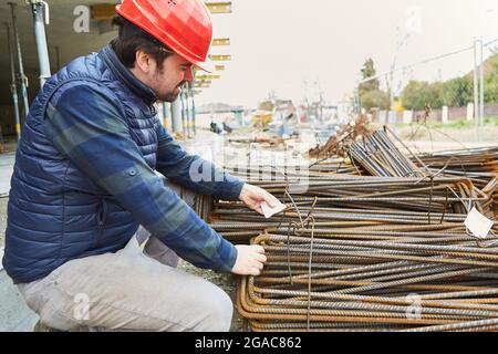 Foreman on the building site in the building shell checks the quality of the reinforcement iron delivery Stock Photo