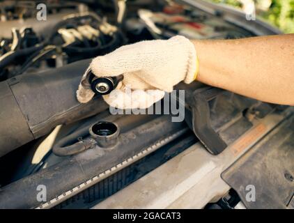 Checking the coolant level in the car's radiator. Closeup photo, natural light. Stock Photo