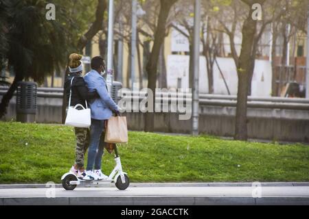 Couple riding on a electric scooter. Stock Photo