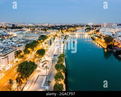 Aerial view of historic part with the river in Seville by the evening, Spain Stock Photo