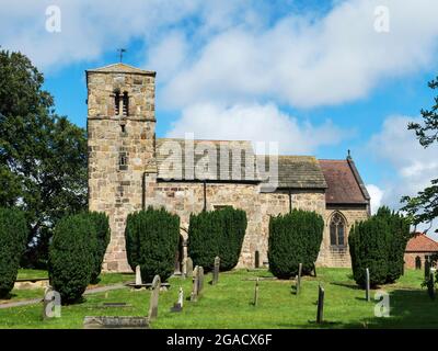 The 11th century or earlier grade I listed Church of St John the Baptist at Kirk Hammerton North Yorkshire England Stock Photo