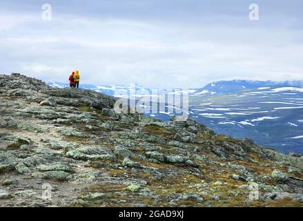 Two backpack hikers on fell mountain top in Lapland Scandinavia Stock Photo