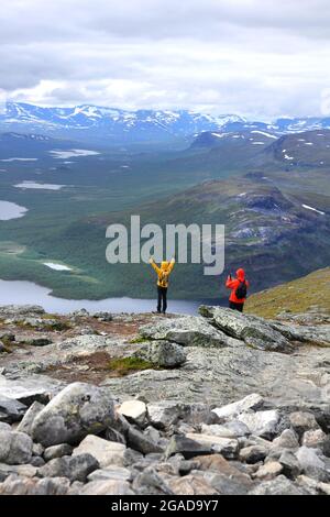 Two backpack hikers high on Saana fell mountain top in Finnish Lapland Scandinavia Stock Photo