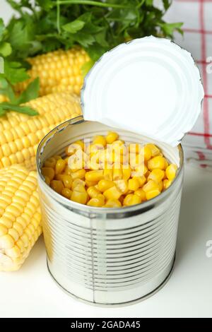 Raw corn and canned corn on white table Stock Photo